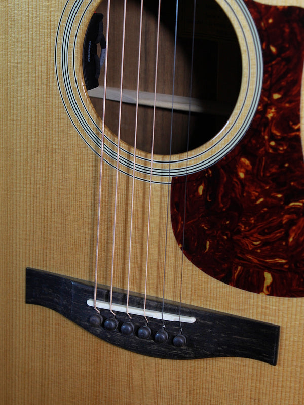 Eastman AC222CE Deluxe solid Sitka Spruce top showing bridge and saddle