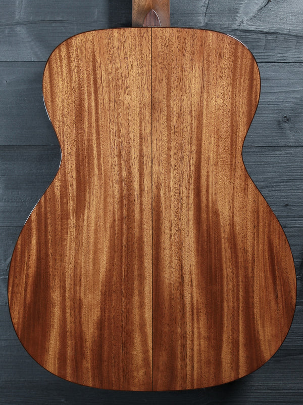 Back of Martin Custom Shop 0000/M guitar showcasing Sinker Mahogany wood grain close up