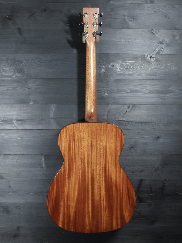 Back of Martin Custom Shop 0000/M guitar showcasing Sinker Mahogany wood grain full back view