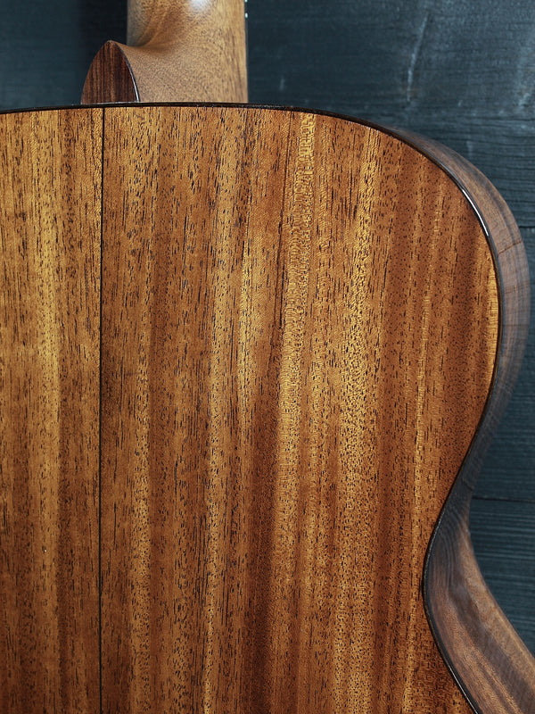 Back of Martin Custom Shop 0000/M guitar showcasing Sinker Mahogany wood grain upper bout view