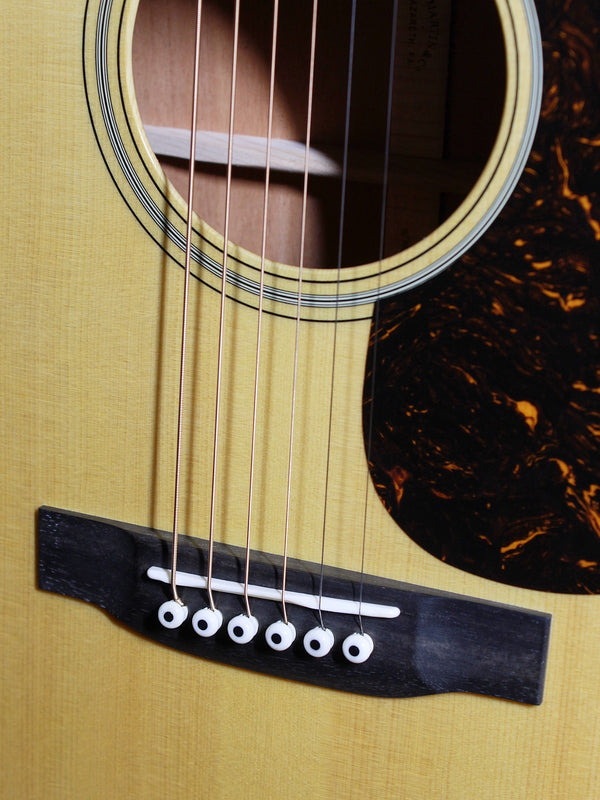 Certified European Spruce top with Aging Toner on Martin Custom Shop acoustic guitar showing bridge and saddle