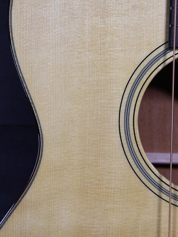Certified European Spruce top with Aging Toner on Martin Custom Shop acoustic guitar showing rosette and soundhole 