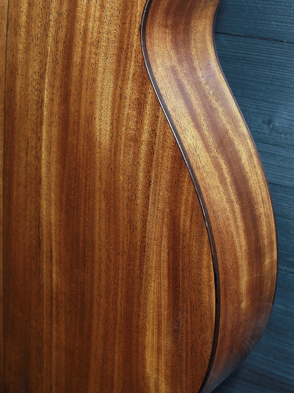 Back of Martin Custom Shop 0000/M guitar showcasing Sinker Mahogany wood grain on back and sides