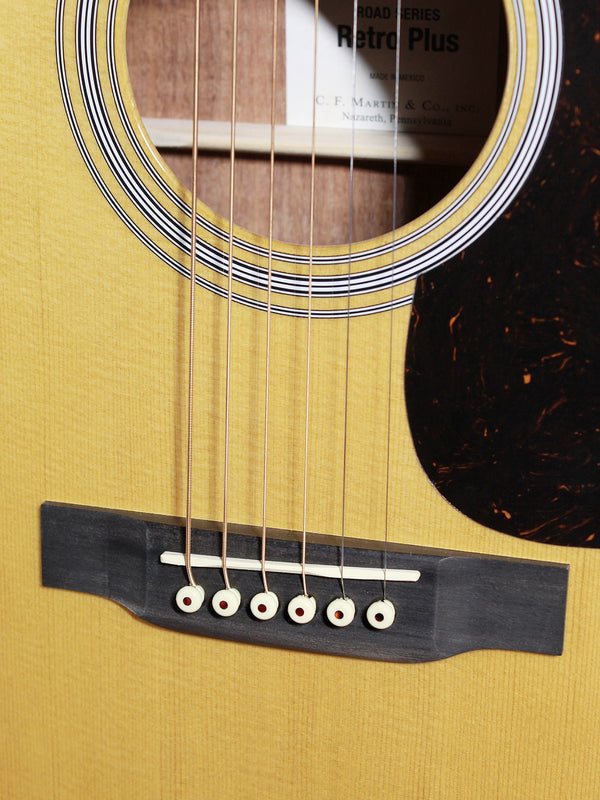 Martin DE Retro Plus Granadillo spruce top acoustic guitar Showing bridge, saddle, pins and strings.