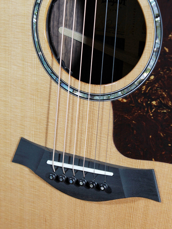 Bridge and saddle detail on Taylor 712ce guitar