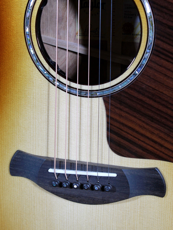 Taylor Builder’s Edition Next Generation 814ce acoustic guitar with Adirondack Spruce top and Shaded Edgeburst finish bridge and saddle.
