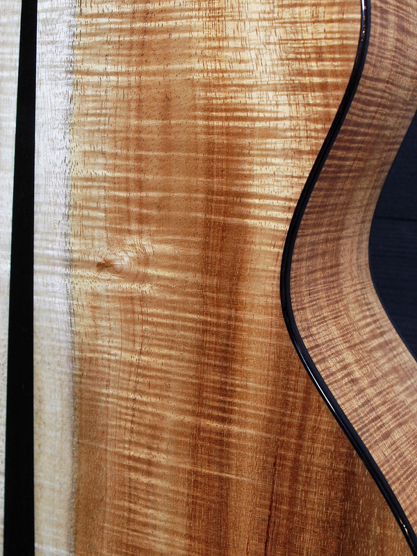Premium Hawaiian Koa back on Taylor Custom acoustic guitar detail of flamed koa wood