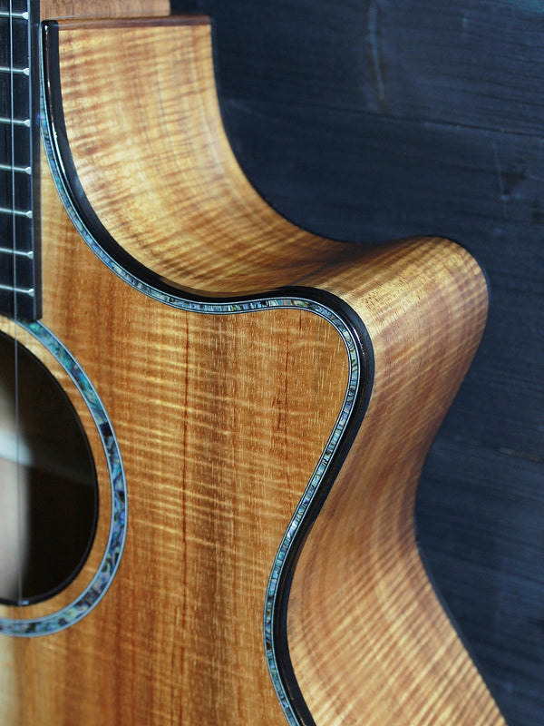Premium Hawaiian Koa back on Taylor Custom acoustic guitar top with cutaway