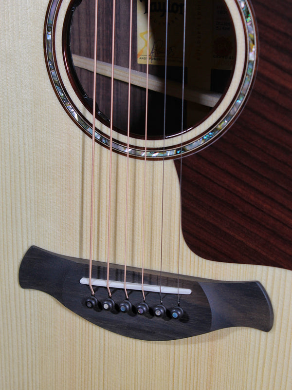 Taylor Next Generation Builder’s Edition 814ce acoustic-electric guitar front view showing bridge and saddle